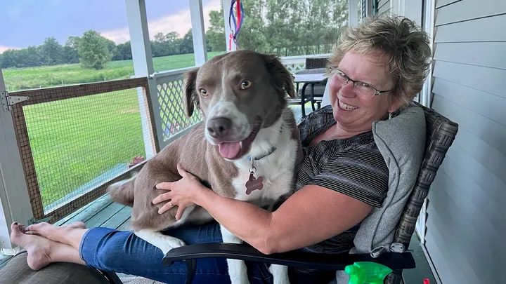 Original photo of a woman holding her dog